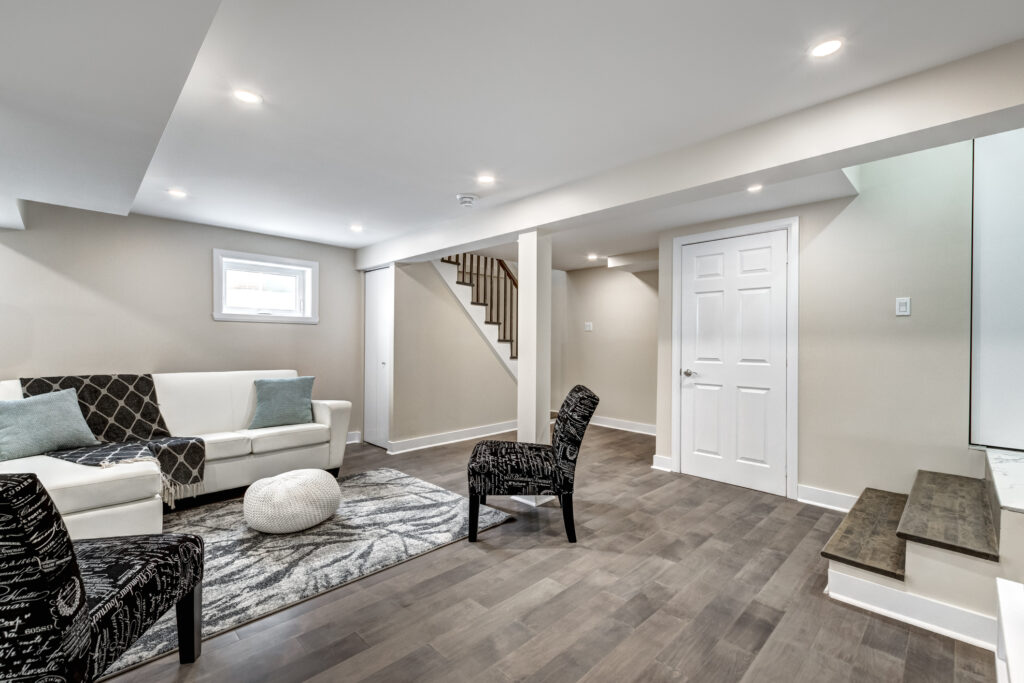 Finished basement remodel with recessed lighting, luxury vinyl plank flooring, updated staircase, and modern finishes. Evansville basement remodel project