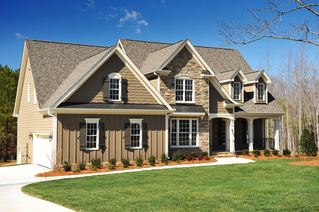 Custom home construction in Evansville, Indiana built by a licensed general contractor featuring stone exterior and covered front porch.