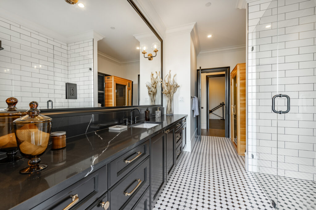 Modern bathroom remodel design with black vanity, subway tile shower, and patterned tile floor – inspiration for bathroom remodeling in Evansville, Indiana.