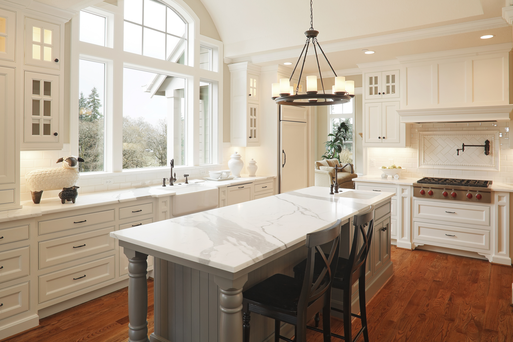 Example of a modern kitchen remodel with white cabinetry and quartz island, similar to projects offered by Seibert Construction in Evansville, Indiana.