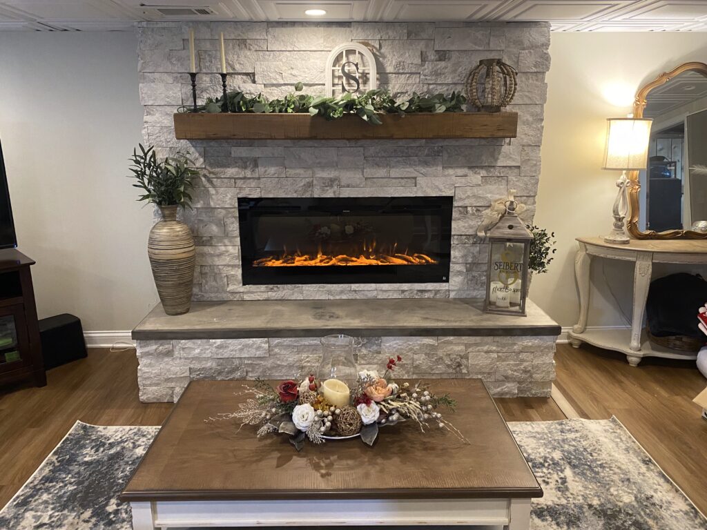 Custom built basement fireplace with natural stone surround and concrete hearth in Haubstadt Indiana