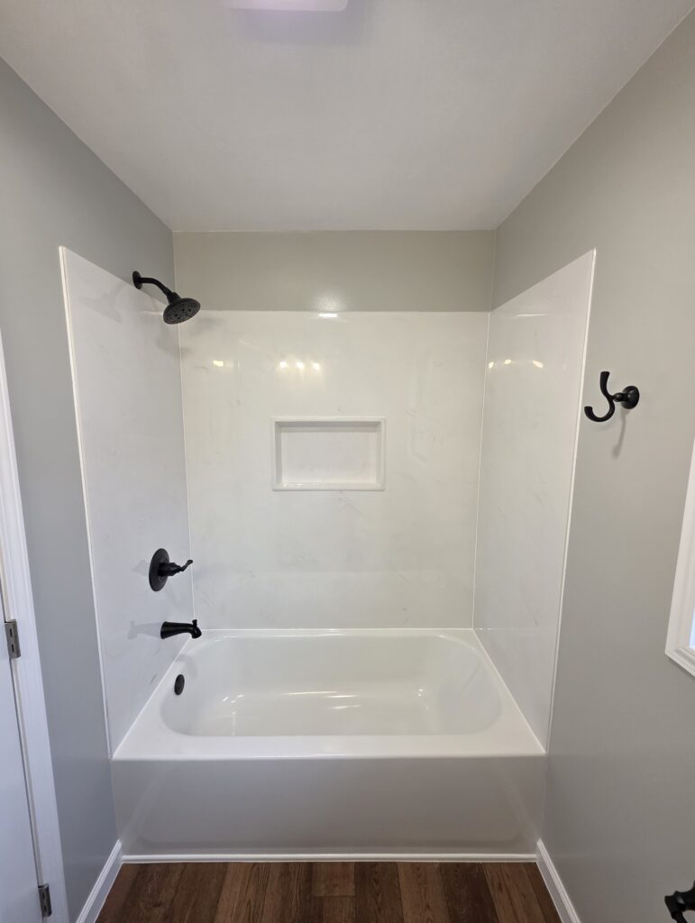 New groutless cultured marble tub and shower surround with custom niche in Wadesville Indiana